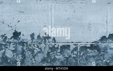Blue concrete wall grunge texture with cracks. Cracks, scrapes, peeling old paint and plaster on background of old cement wall. An old cement stone wall as vintage cracked. Stock Photo