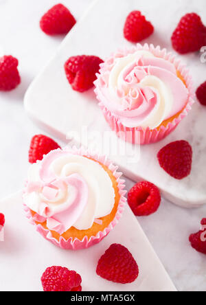 Cupcake muffin with raspberry cream dessert on marble background with freshraspberry Stock Photo