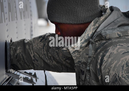 U.S. Air National Guard member Tech. Sgt. Kye Dudley from the 146th Maintenance Squadron inspects the landing gear of a C-130J aircraft at Gowen Field, Idaho, April 20, 2017. Sgt. Dudley and a maintenance crew from the 146th Airlift Wing will be providing maintenance service on two C-130J aircraft equipped with the Modular Airborne Fire Fighting System (MAFFS) from the Channel Islands Air National Guard Station during the week-long multi-agency wildfire training with the U.S. Forest Service, CAL FIRE, and multiple Air National Guard and U.S. Air Force Reserve wings. Stock Photo