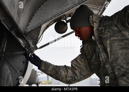 U.S. Air National Guard member Tech. Sgt. Kye Dudley from the 146th Maintenance Squadron inspects the landing gear of a C-130J aircraft at Gowen Field, Idaho, April 20, 2017. Sgt. Dudley and a maintenance crew from the 146th Airlift Wing will be providing maintenance service on two C-130J aircraft equipped with the Modular Airborne Fire Fighting System (MAFFS) from the Channel Islands Air National Guard Station during the week-long multi-agency wildfire training with the U.S. Forest Service, CAL FIRE, and multiple Air National Guard and U.S. Air Force Reserve wings. Stock Photo