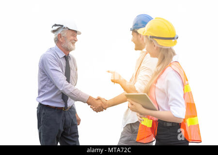 Group of male and female engineers celebration success happiness with shaking hands at construction site. Teamwork and success concepts. Isolated on w Stock Photo
