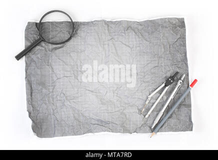 Still life photo of engineering graph paper with a pencils, compass and magnifier, blank to add your own design, image or text. Stock Photo