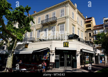 Cannes France - May 11, 2018:  American fast food restaurant McDonalds on Rue Félix Faure in the resort town that caters to the rich. Stock Photo