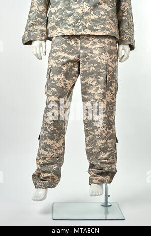 Feet of mannequin in military uniform. White isolated background. Stock Photo
