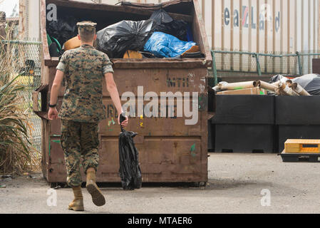 Pfc. Michael Powell, an artillery mechanic with Combat Logistics Battalion 3, throws away trash during a base wide cleanup at the recycling center aboard Marine Corps Base Hawaii on April 20, 2017. The semiannual cleanup event, “Malama Ka Aina,” is dedicated to cleaning MCB Hawaii, Pu’uola Rifle Range, Marine Corps Training Area Bellows, and Camp Smith. Malama Ka Aina is Hawaiian for “care for the land,” where Marines and Sailors from various units aboard MCB Hawaii work together to help keep each military installation litter free.