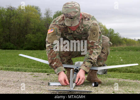 Sgt. Nicholas Hammond, an aviation operations sergeant with Headquarters and Headquarters Company, 1-137th Aviation Regiment, assembles the RQ-11B Raven during training operations this spring at Camp Sherman Joint Training Center in Chillicothe, Ohio. The Raven is a Small Unmanned Aircraft System (SUAS) that provides real-time, full-motion video and sensor data to help Soldiers develop situational awareness, enhance force protection and secure routes, points and areas. (Ohio National Guard Stock Photo