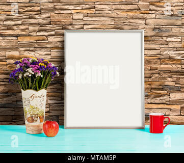 Silver frame mockup with field flowers in vase, apple and mug. Empty frame mock up for presentation design. Template framing for modern art. Stock Photo