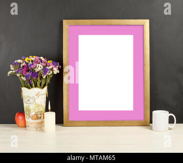 Fame mockup with field flowers in vase, apple, mug and candle. Empty frame mock up for presentation design. Template framing for modern art. Stock Photo