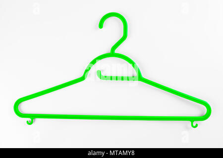 Green plastic hanger for clothes on a white background Stock Photo
