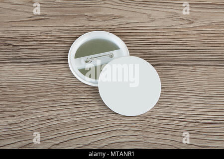 White Badges front and back view on a wooden background Stock Photo