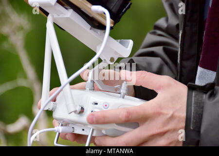 Detail of drone operator with white transmitter in hand with first person view system Stock Photo