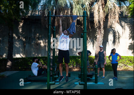 09.05.2018, Sydney, New South Wales, Australia - People are seen exercising and doing pull-ups at the Observatory Hill Outdoor Gym. Stock Photo