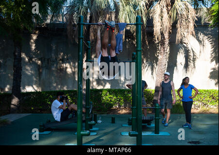 09.05.2018, Sydney, New South Wales, Australia - People are seen exercising and doing pull-ups at the Observatory Hill Outdoor Gym. Stock Photo
