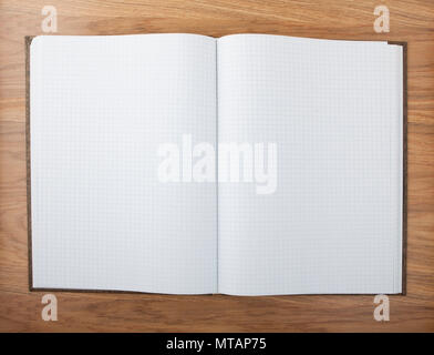 Blank squared notebook sheets on a table Stock Photo