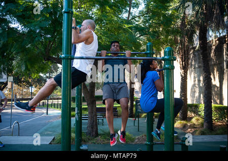 09.05.2018, Sydney, New South Wales, Australia - People are seen exercising and doing pull-ups at the Observatory Hill Outdoor Gym. Stock Photo