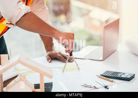 landscape engineering using Geometric compasses on the land map Stock Photo