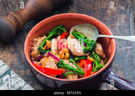 Sichuan pork, broccoli, red pepper and cashew stir-fry Stock Photo