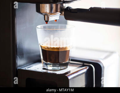 Espresso coffee pouring from coffee machine, espresso coffee drink Stock Photo