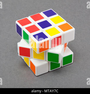 Rubik's cube (white, red, blue, orange, green, and yellow) on gray background. Six color cube puzzle with clipping path Stock Photo