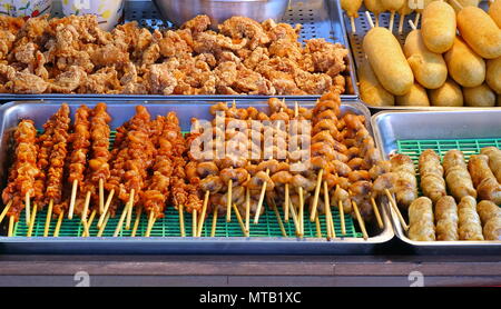 A street vendor sells fried chicken, meat skewers and corn dogs Stock Photo