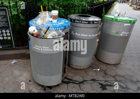 Garbage and mixed recyclables placed in the wrong color coded trash bin in New York City Stock Photo