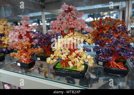 Colourful crystal gemstone trees on display Stock Photo