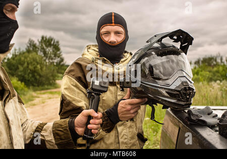 Close up of Two men outdoors wearing balaclava helmets and motor Stock Photo