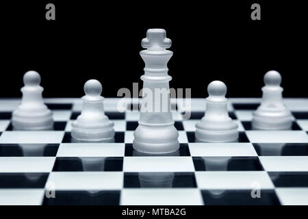 Chess game strategy. King and three pawns lined up. Concept of teamwork, leadership and solidarity. Stock Photo