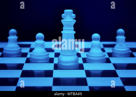 Chess game strategy. King and three pawns lined up. Concept of teamwork, leadership and solidarity. Stock Photo