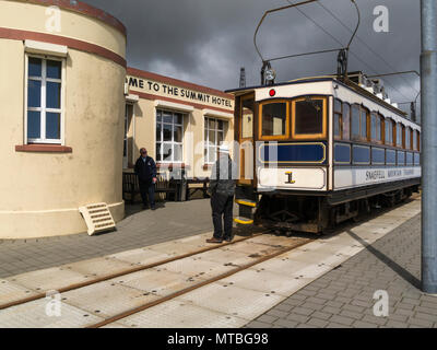 Snaefell Mountain Railway at Summit Station next to Summit Hotel the highest point on  Isle of Man ticket collector speaking to passenger Stock Photo