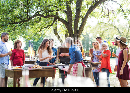 Family celebration or a barbecue party outside in the backyard. Stock Photo