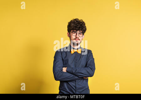 Portrait of a young man in a studio on a yellow background. Stock Photo