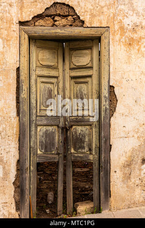 Abstract details of old wooden doors, neglected with peeling paintwork and broken glass, Vilaflor, Canary Islands, Spain, Stock Photo