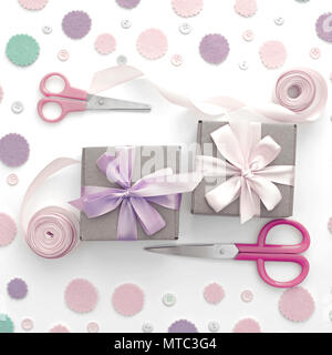 Two gift boxes on festive pastel confetti background. Wrapping gifts in Kraft boxes with a satin ribbon bow scissors. Flat lay top view Stock Photo