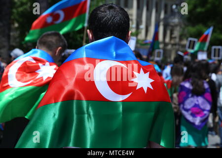 Azerbaijan flag in Baku, Azerbaijan. National sign background. The boy put a flag on his shoulder.. Azerbaijan tradition patriotic. Flags waving wind Stock Photo