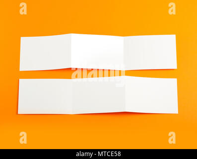 Blank folding page booklet on orange background Stock Photo