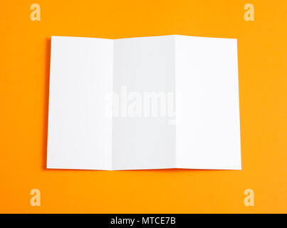 Blank folding page booklet on orange background Stock Photo