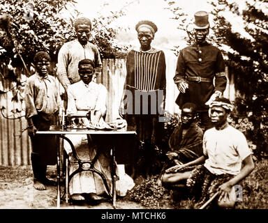 Group of people in Natal, Africa with a sewing machine, early 1900s Stock Photo