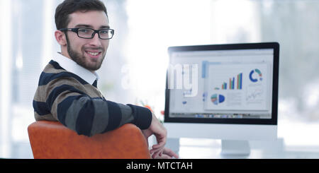 businessman analyzing financial graphs on computer Stock Photo