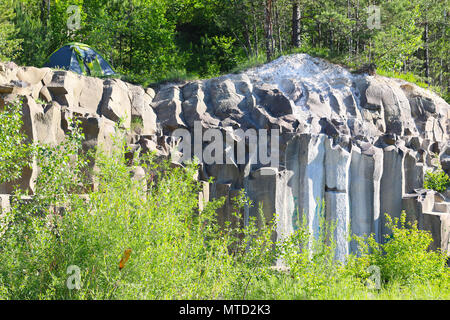 Tent weekend on basalt columns. Beautiful geological landscape Stock Photo