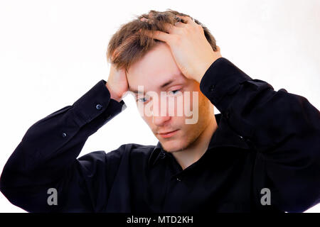 A distressed guy grabbed his head.Awareness of the problem, mistakes, misfortune Stock Photo