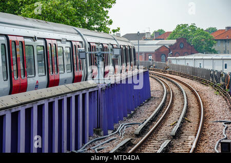 A London Underground train arriving into Wood Lane Station on The London Underground. Stock Photo