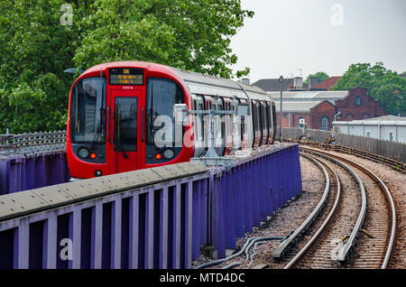 A London Underground train arriving into Wood Lane Station on The London Underground. Stock Photo