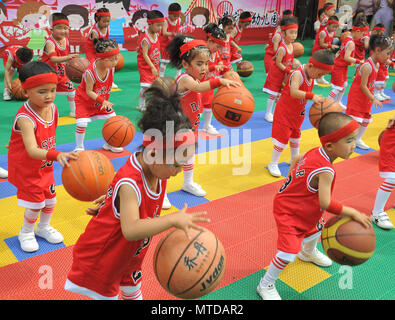 Yuncheng, China's Shanxi Province. 29th May, 2018. A group of children play basketball during a performance at a kindergarten in Jishan County, Yuncheng, north China's Shanxi Province, May 29, 2018. Various activities were held across China to celebrate the upcoming International Children's Day. Credit: Li Lujian/Xinhua/Alamy Live News Stock Photo