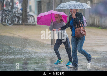 Southbank, London. 29th May, 2018. UK Weather: People struggle with umbrellas as they try to walk around the Southbank in the wind and rain. Credit: Guy Bell/Alamy Live News Stock Photo