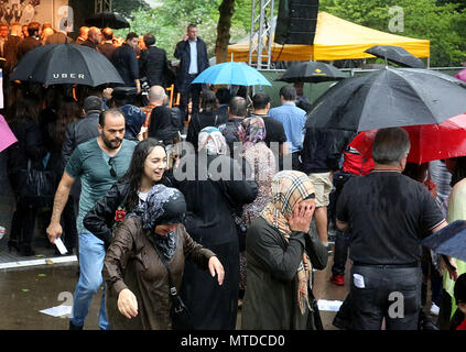 Solingen, Germany. 29 May 2018, Visitors leave the memorial event for the arson attack of Solingen. The event had to be cancelled due to a storm. 25 years after the racially motivated arson attack of Solingen, the victims are honoured with two events. In the night of 29 May 1993, four right-wing extremists set fire to the house of the Turkish family Genc in North Rhine-Westphalia. Credit: dpa picture alliance/Alamy Live News Stock Photo