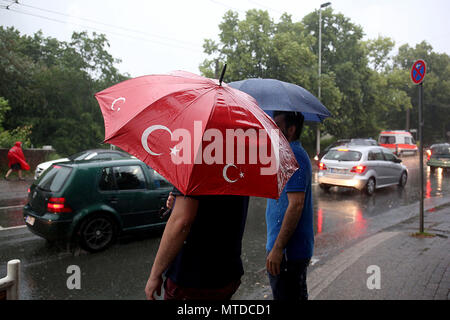 Solingen, Germany. 29 May 2018, Visitors leave the memorial event for the arson attack of Solingen. The event had to be cancelled due to a storm. 25 years after the racially motivated arson attack of Solingen, the victims are honoured with two events. In the night of 29 May 1993, four right-wing extremists set fire to the house of the Turkish family Genc in North Rhine-Westphalia. Credit: dpa picture alliance/Alamy Live News Stock Photo