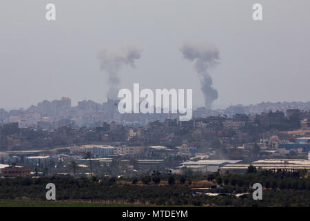 Jerusalem. 29th May, 2018. Smoke rises from Gaza Strip on May 29, 2018. Palestinian militants fired dozens of mortars, projectiles and rockets into Israel throughout Tuesday before Israel launched a wide-scale airstrike on Gaza, as tensions rise following weeks of lethal Israeli fire at Gaza protestors. Credit: JINI/Xinhua/Alamy Live News Stock Photo