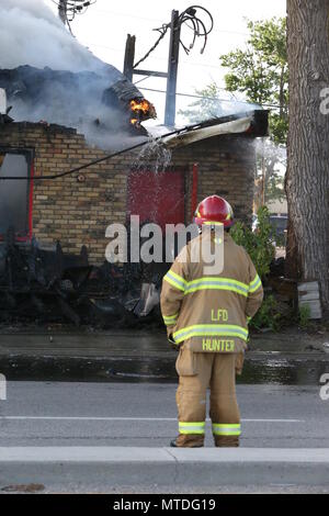 London Ontario, Canada. May 29th 2018, London, Ontario Canada, Fire broke out at the old Hooks restaurant around 5:15pm today at the corner of Southdale and Wharncliffe in London Ontario,  Fire crews were battling the flames for hours and had the blaze tame round 8 pm.  Even though the restaurant has not been open years, Londoners still have great memories and are sad to let this building go. Luke Durda/alamy Live news. Stock Photo