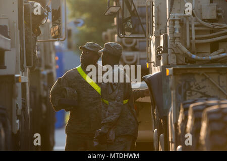 30 May 2018, Germany, Burg: Soldiers of the US military forces waiting to refuel their lorries at the Clausewitz military barracks. The men and women belong to the 1st armoured brigade of the 1st cavalry division. After the arrival of the group in Antwerp, the troups are headed east on the federal motorway A2 through Saxony-Anhalt. The destination of the vehicles are several location in Poland. The soldiers are to be deployed as part of the US-operation 'Atlantic Resolve'. Photo: Klaus-Dietmar Gabbert/dpa-Zentralbild/dpa Stock Photo